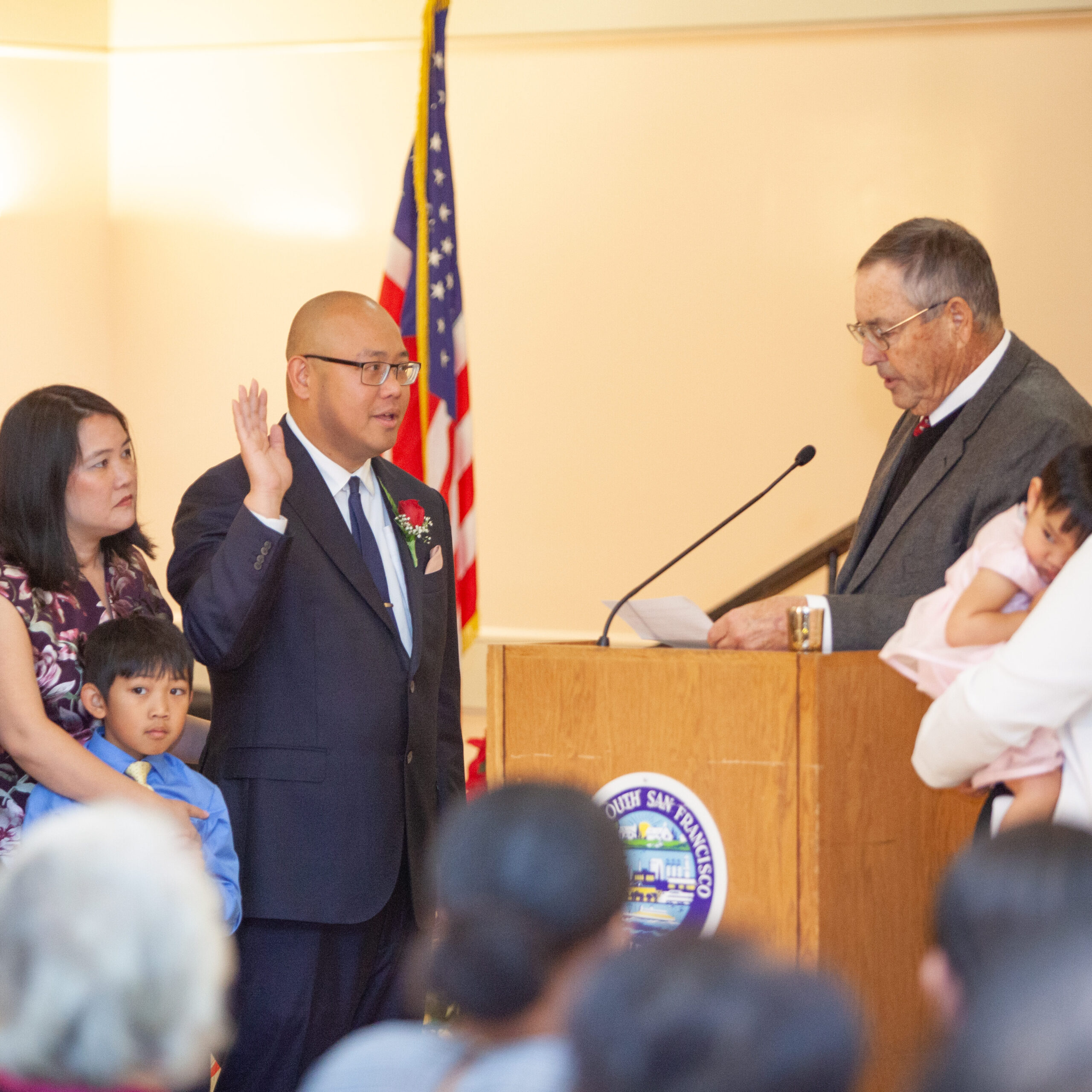 Mark Nagales is surrounded by his family as he is sworn in to the South San Francisco City Council by former Assemblymember Gene Mullin, 2018.